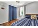 Inviting bedroom featuring hardwood floors and soothing natural light through a window with custom drapes at 152 Dana Dr, Fayetteville, GA 30215