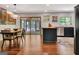 Dining area with hardwood floors, modern lighting, and sliding glass doors to the backyard at 152 Dana Dr, Fayetteville, GA 30215