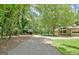 Long driveway leading to a home with attached garage and covered parking in wooded area at 152 Dana Dr, Fayetteville, GA 30215
