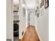 Hallway with hardwood flooring featuring an in-unit laundry area with washer and dryer at 152 Dana Dr, Fayetteville, GA 30215