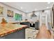 Modern kitchen with butcher block countertops, stainless steel appliances and large window at 152 Dana Dr, Fayetteville, GA 30215