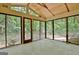 Screened porch with wood ceiling and views of the private, wooded backyard at 152 Dana Dr, Fayetteville, GA 30215
