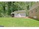An outdoor white storage shed sits in the backyard on a well-maintained, grassy lawn at 152 Dana Dr, Fayetteville, GA 30215