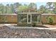 A sunroom with glass windows is attached to a brick home in a serene wooded area at 152 Dana Dr, Fayetteville, GA 30215