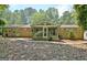 A sunroom with glass windows is attached to a brick home in a serene wooded area at 152 Dana Dr, Fayetteville, GA 30215