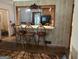 Cozy breakfast bar area with traditional stools, wood accents, and a view into the kitchen at 4884 Maurice Nw Dr, Lilburn, GA 30047