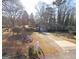 Single-story home with carport and long driveway, seen from above at 4884 Maurice Nw Dr, Lilburn, GA 30047