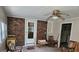 Enclosed sunroom featuring brick wall, ceiling fan and rocking chairs at 4884 Maurice Nw Dr, Lilburn, GA 30047