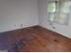 Bedroom featuring hardwood floors, a window and white walls at 1417 Lake Cir, Mableton, GA 30126