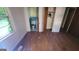 Bedroom featuring hardwood floors, a window and an open closet leading to the bathroom at 1417 Lake Cir, Mableton, GA 30126