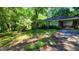 View of the house, surrounded by mature trees and greenery creating a private and natural setting at 1417 Lake Cir, Mableton, GA 30126