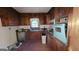 Vintage kitchen featuring wood cabinets, a blue oven and sink with a window above the sink at 1417 Lake Cir, Mableton, GA 30126