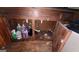 Image shows the plumbing, open cabinet, and various cleaning products beneath a kitchen or bathroom sink at 1417 Lake Cir, Mableton, GA 30126