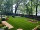 Lush backyard with a manicured lawn, mature trees, and charming landscaping at 2134 Main Nw St, Atlanta, GA 30318