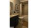 Elegant bathroom with a granite vanity, modern fixtures, and a tiled shower-tub combination for a relaxing experience at 2134 Main Nw St, Atlanta, GA 30318