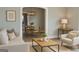 Cozy living room with modern furnishings, neutral tones, and an inviting open concept layout to the dining area at 2134 Main Nw St, Atlanta, GA 30318