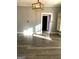Bright living room showcasing gray walls, modern light fixture, and wood-look floors with a glimpse into another room at 2134 Main Nw St, Atlanta, GA 30318