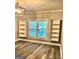 Living room featuring wood-look flooring, built in shelving, and double-paned windows for natural light at 2134 Main Nw St, Atlanta, GA 30318