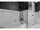 Retro bathroom featuring a tub with shower and textured tile wall at 7121 Forest Se Dr, Covington, GA 30014