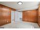 Bedroom featuring wood paneled walls, carpeted floors, and an interior door way at 7121 Forest Se Dr, Covington, GA 30014