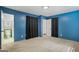 Blue bedroom featuring carpet, a connecting bathroom, and a spacious closet at 7121 Forest Se Dr, Covington, GA 30014