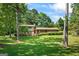 Charming two-story home with brick facade, red shutters, and well-maintained landscaping in a lush, green setting at 7121 Forest Se Dr, Covington, GA 30014