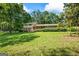 Charming two-story home with brick facade, red shutters, and well-maintained landscaping in a lush, green setting at 7121 Forest Se Dr, Covington, GA 30014