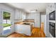 Bright kitchen with wood countertops, white cabinets, hardwood floors, and stainless steel appliances at 7121 Forest Se Dr, Covington, GA 30014