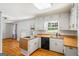Bright kitchen with wood countertops, white cabinets, hardwood floors, and a view into the living room at 7121 Forest Se Dr, Covington, GA 30014