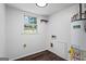A bright laundry area featuring wood-look floors and a water heater at 7121 Forest Se Dr, Covington, GA 30014