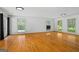 Bright living room featuring hardwood floors, white walls, and natural light through large windows at 7121 Forest Se Dr, Covington, GA 30014