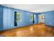 Bright living room with hardwood floors, neutral paint, and large windows for plenty of natural light at 7121 Forest Se Dr, Covington, GA 30014