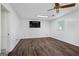 Spacious room with wood-look floors, a ceiling fan, and a window, freshly painted white at 7121 Forest Se Dr, Covington, GA 30014