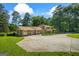 Back of home featuring brick chimney, fenced yard, and nice driveway at 7121 Forest Se Dr, Covington, GA 30014