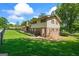 Back of home featuring brick chimney, fenced yard, and nice driveway at 7121 Forest Se Dr, Covington, GA 30014