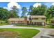 Back of home featuring brick chimney, fenced yard, and nice driveway at 7121 Forest Se Dr, Covington, GA 30014