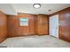 Room featuring wood paneled walls, carpeted floors, and a built-in cabinet at 7121 Forest Se Dr, Covington, GA 30014