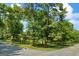 Street view of landscaped lawn featuring a 'Dead End' sign with mature trees and shrubs providing shade at 7121 Forest Se Dr, Covington, GA 30014