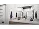 Modern bathroom features a double sink vanity with a white marble countertop and dark fixtures at 1212 Trombone Way # 107, Mcdonough, GA 30252