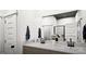 Modern bathroom features a double sink vanity with a white marble countertop and dark fixtures at 1212 Trombone Way # 107, Mcdonough, GA 30252