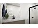 Modern bathroom with white walls, sleek black fixtures, and glass enclosed shower at 1212 Trombone Way # 107, Mcdonough, GA 30252