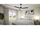 Cozy bedroom features a plush bed with white and grey bedding, framed artwork, and natural light at 1212 Trombone Way # 107, Mcdonough, GA 30252