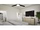 Bright bedroom features a ceiling fan, a TV, a dresser, and a potted plant at 1212 Trombone Way # 107, Mcdonough, GA 30252