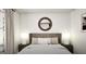 Inviting bedroom with a comfortable bed, round mirror, and soft, natural light at 1212 Trombone Way # 107, Mcdonough, GA 30252