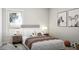 Well-lit bedroom featuring a comfortable bed and unique artwork at 1212 Trombone Way # 107, Mcdonough, GA 30252