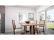 Bright dining area with a wooden table, four chairs, and natural light from a window at 1212 Trombone Way # 107, Mcdonough, GA 30252