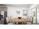 Bright dining area with a wooden table, four chairs, and natural light from a window at 1212 Trombone Way # 107, Mcdonough, GA 30252