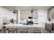 Modern kitchen with stainless steel appliances, quartz countertops, and stylish pendant lighting at 1212 Trombone Way # 107, Mcdonough, GA 30252