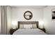 A bedroom featuring a large bed, round mirror, and ambient lighting for a relaxing atmosphere at 100 Trombone Way, Mcdonough, GA 30252
