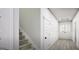 Bright hallway with staircase and a modern wainscoting design leading to glass doors at 100 Trombone Way, Mcdonough, GA 30252